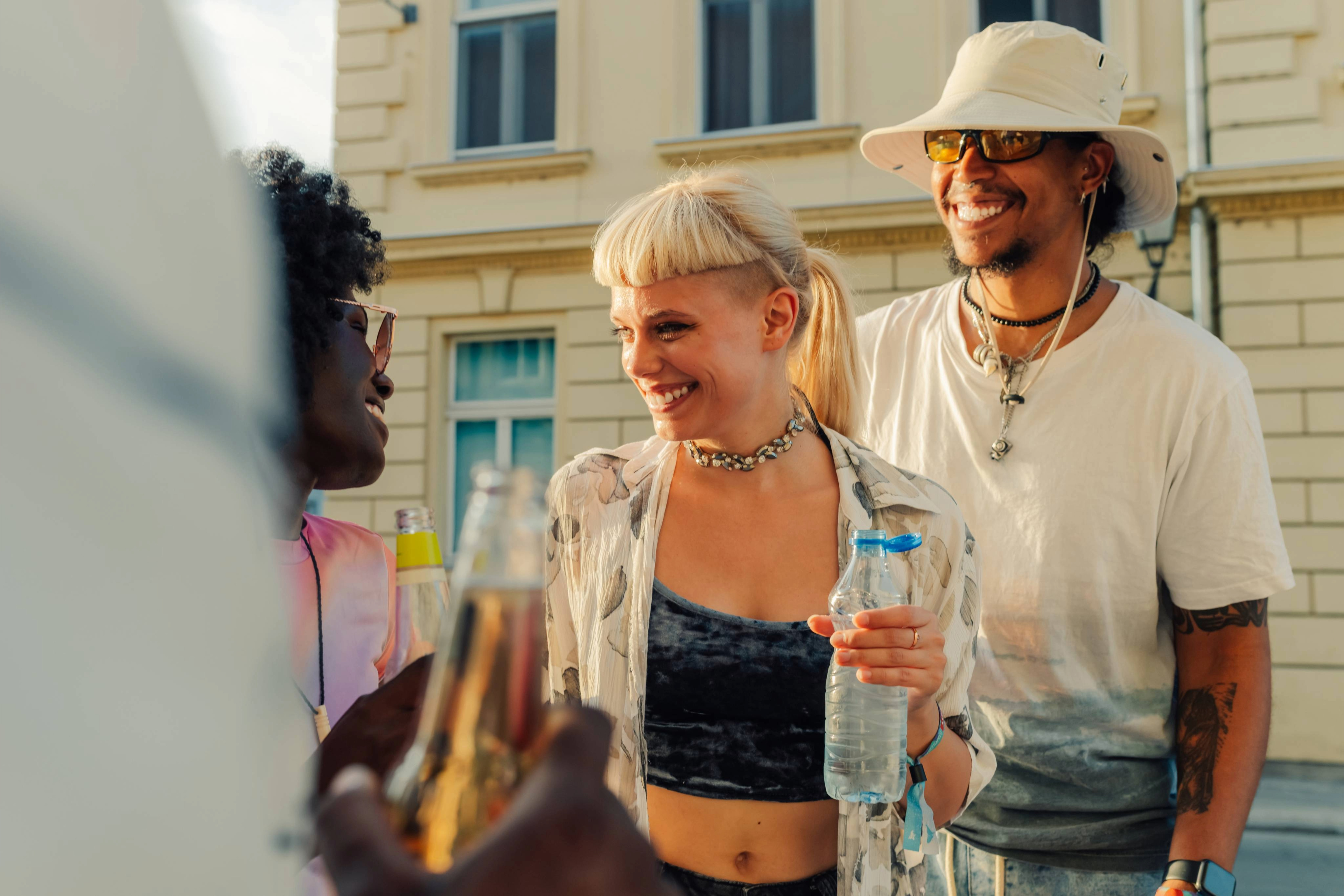 Two couples laugh and talk while getting drinks